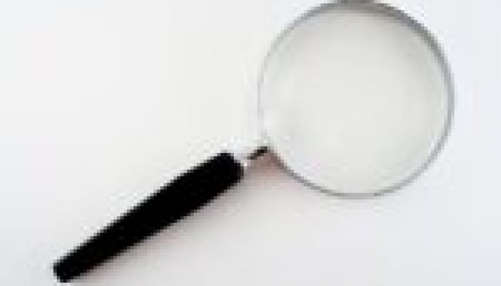 Image of a magnifying glass for an article about what to look for in procurement software solutions.
