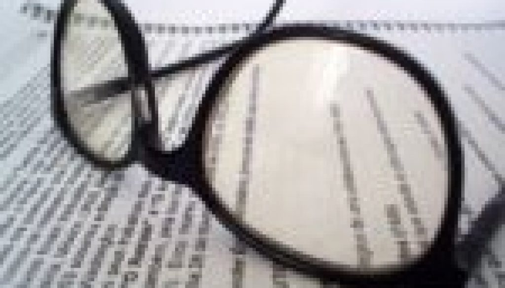 Image of glasses and a report for an article about How To Get the Most From Your Spend Analysis Reports.