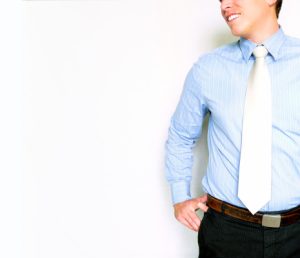 Image of a businessman in a blue button down and white tie for an article about 5 eSourcing Benefits for buyers and suppliers.